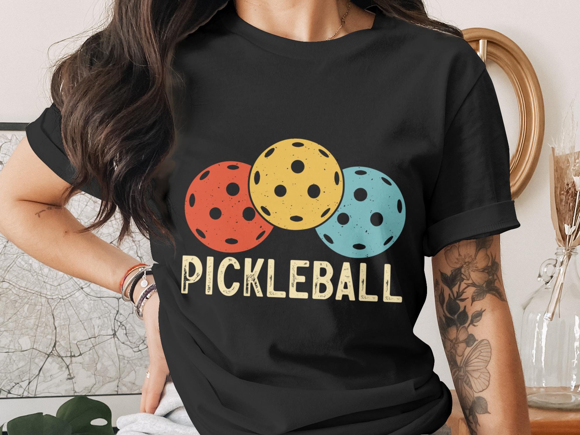 Black t-shirt with three colorful pickleballs and the text "PICKLEBALL".