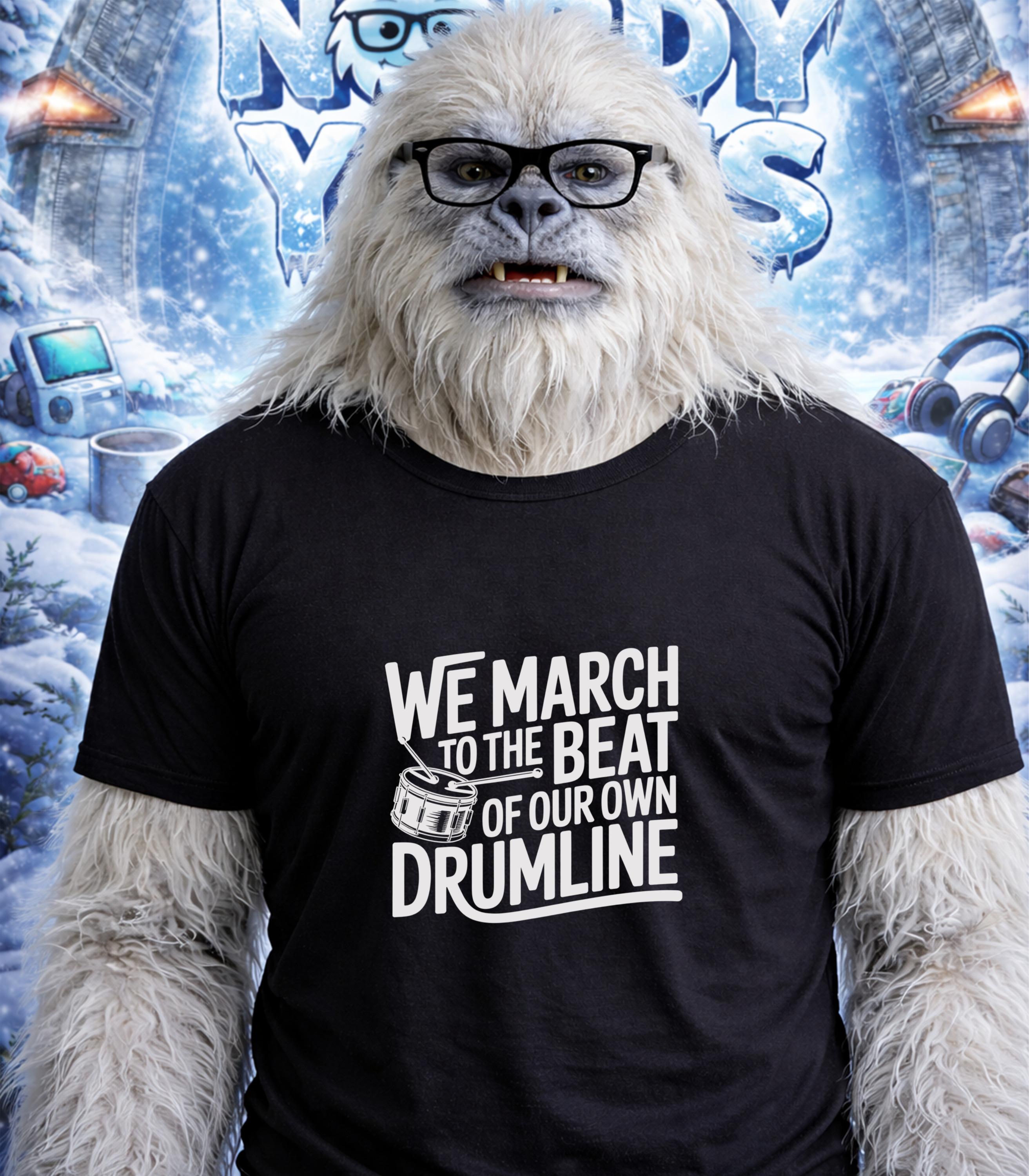 Yeti wearing glasses and a t-shirt with "We March to the Beat of Our Own Drum" text.