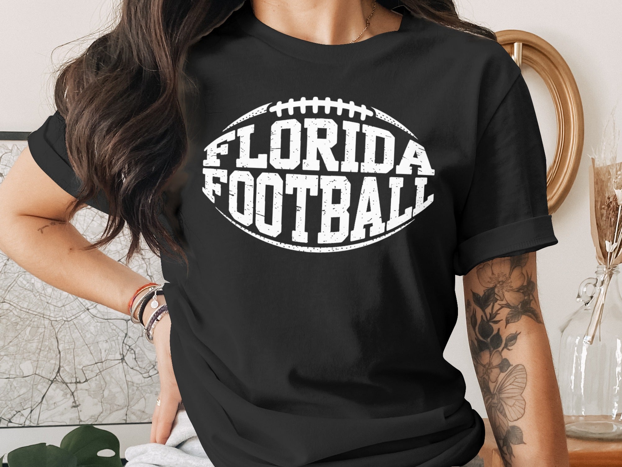 Black t-shirt with white "Florida Football" text and a football graphic.