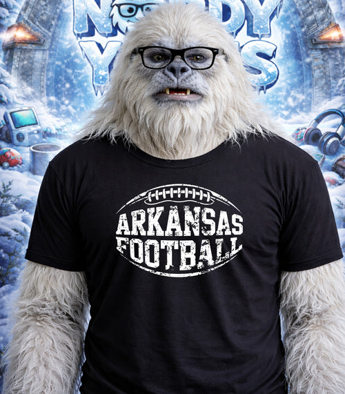 Yeti wearing a black t-shirt with "Arkansas Football" and a football graphic.