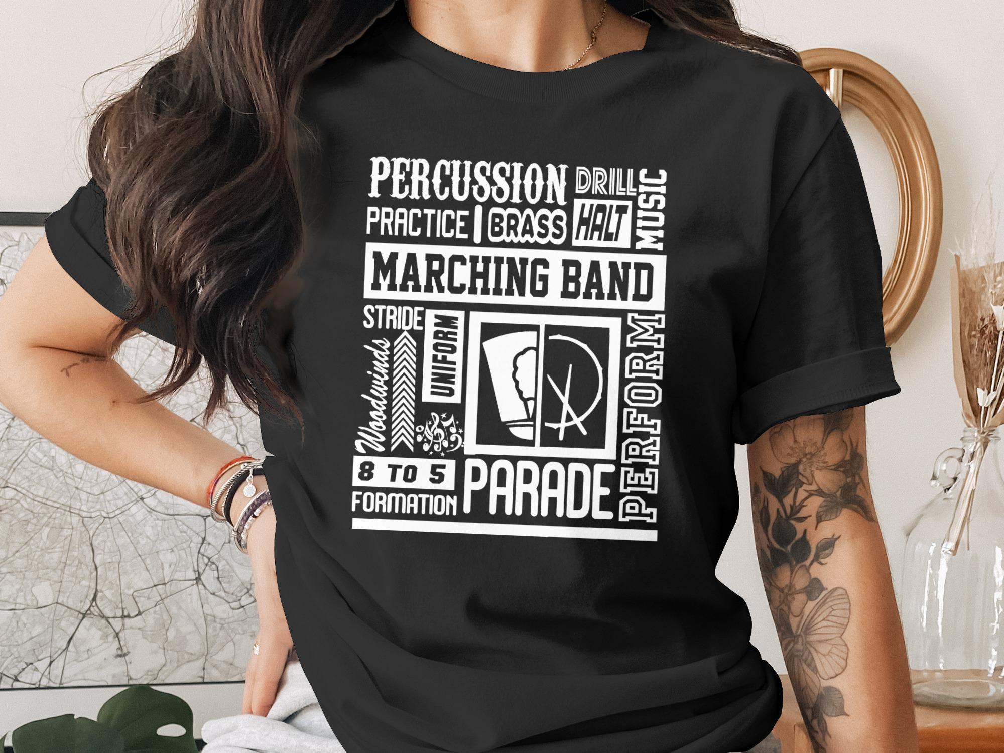 Black t-shirt with white text detailing marching band terms and activities.