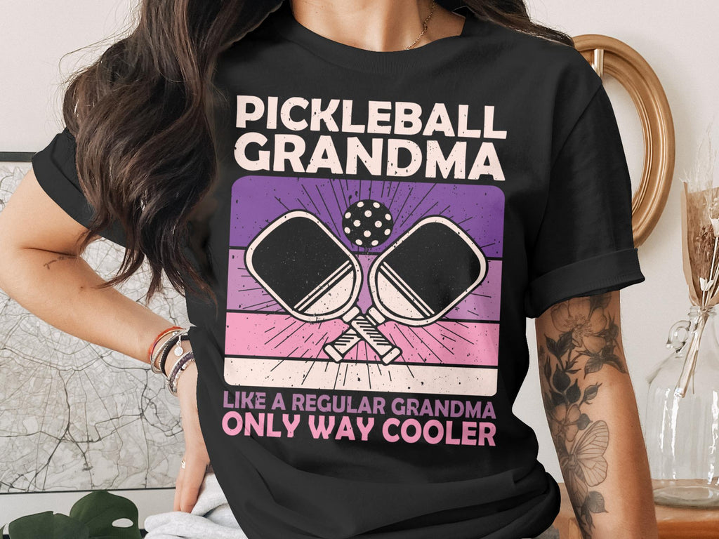Black t-shirt with "Pickleball Grandma" and crossed paddles graphic.