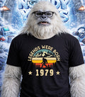 Yeti wearing a black t-shirt with "Legends Were Born 1979" and mountain graphic.