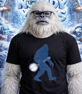 Yeti wearing glasses and a t-shirt with a banjo-playing Bigfoot silhouette.