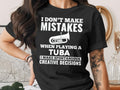 Black t-shirt with white text "I Don't Make Mistakes When Playing A Tuba, I Make Spontaneous Creative Decisions" and tuba graphic.