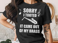 Black t-shirt with white text and saxophone graphic reading "Sorry I Tooted It Came Out Of My Brass".
