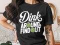 Black t-shirt with "Dink Around & Find Out" text and pickleball graphics.
