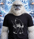 Yeti wearing glasses and a t-shirt with a fishing Bigfoot graphic.