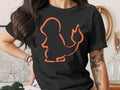 Black t-shirt with an orange outline of the Pokémon Charmander.