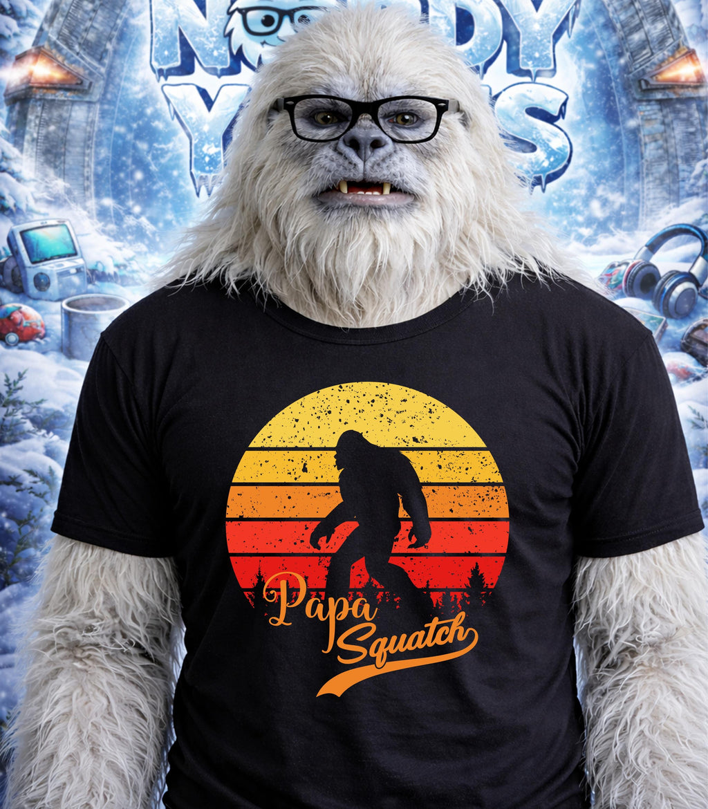Yeti wearing glasses and a "Papa Squatch" t-shirt against a snowy background.