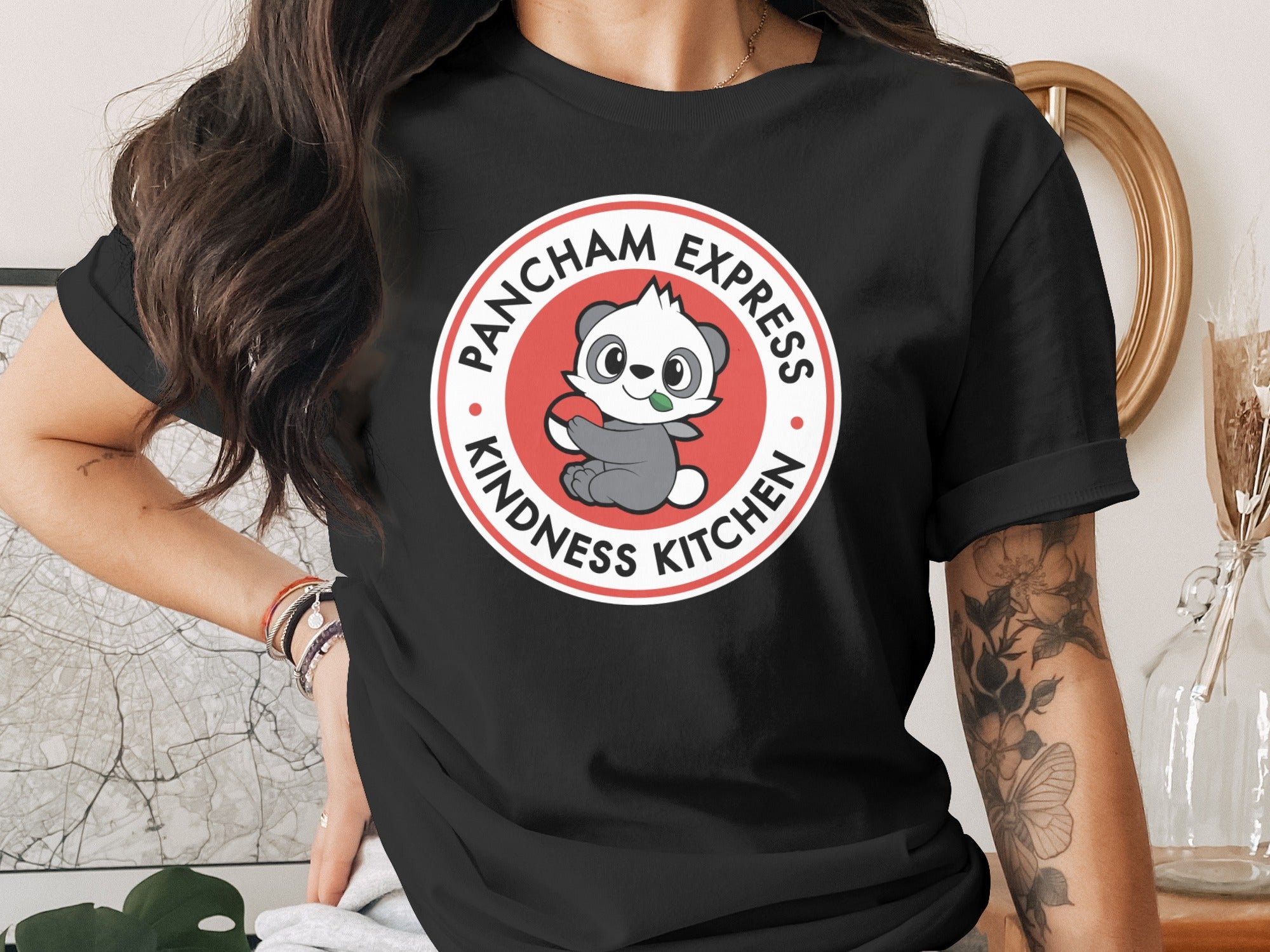 Black t-shirt with a circular logo for "Pancham Express Kindness Kitchen."