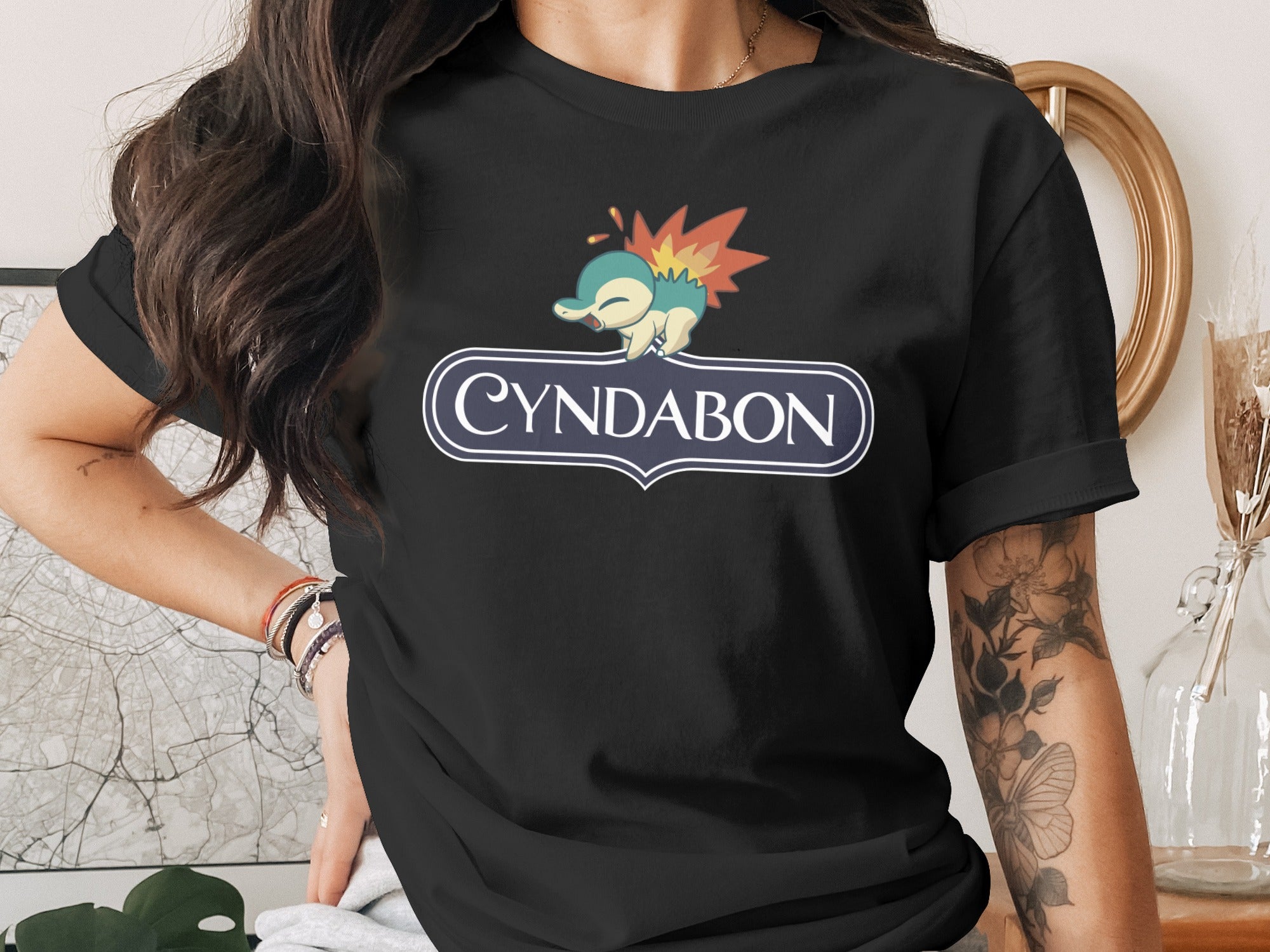 Black t-shirt with Cyndabun logo and cartoon character.