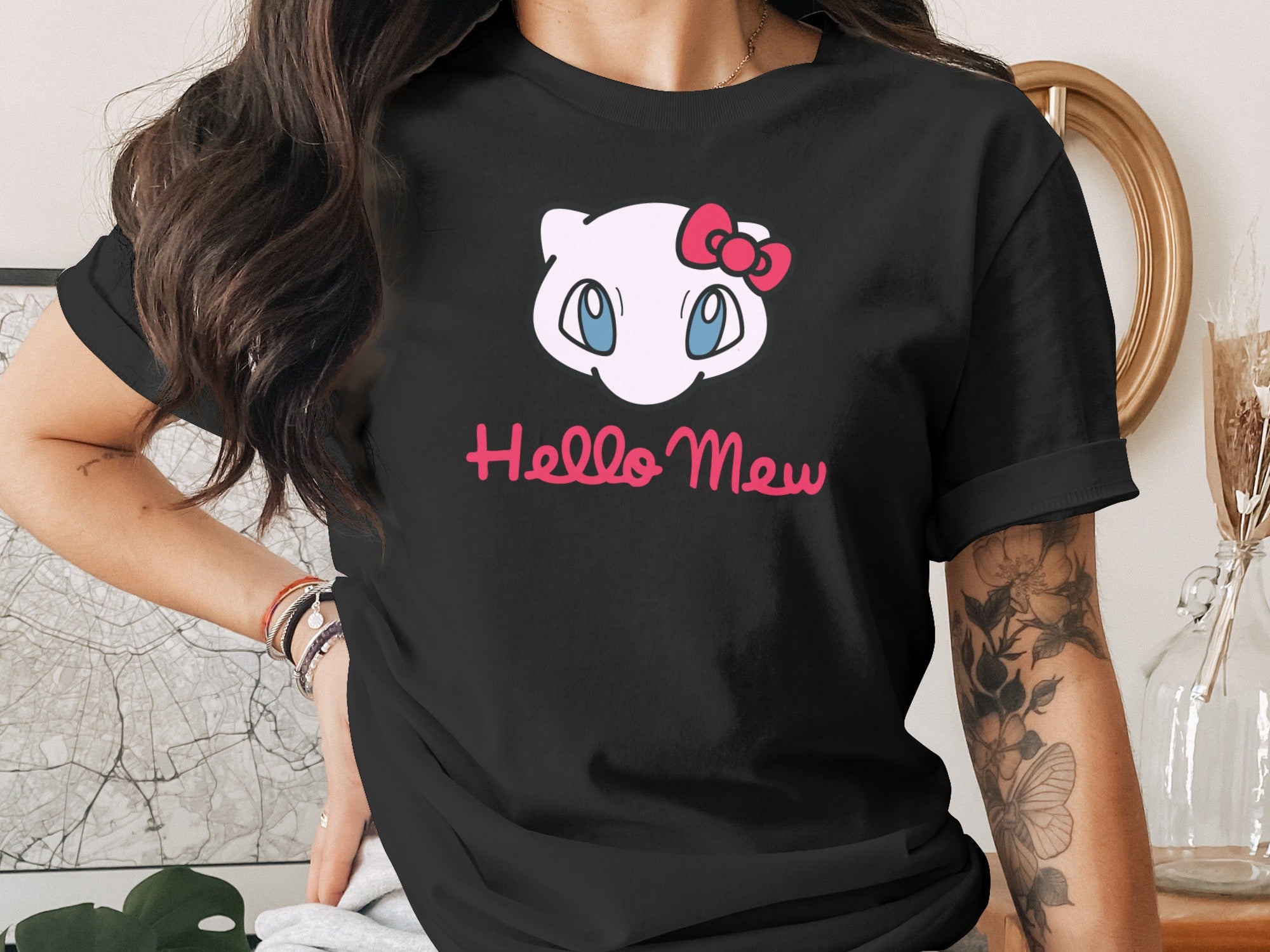 Black t-shirt with "Hello Mew" and a Hello Kitty-like character.