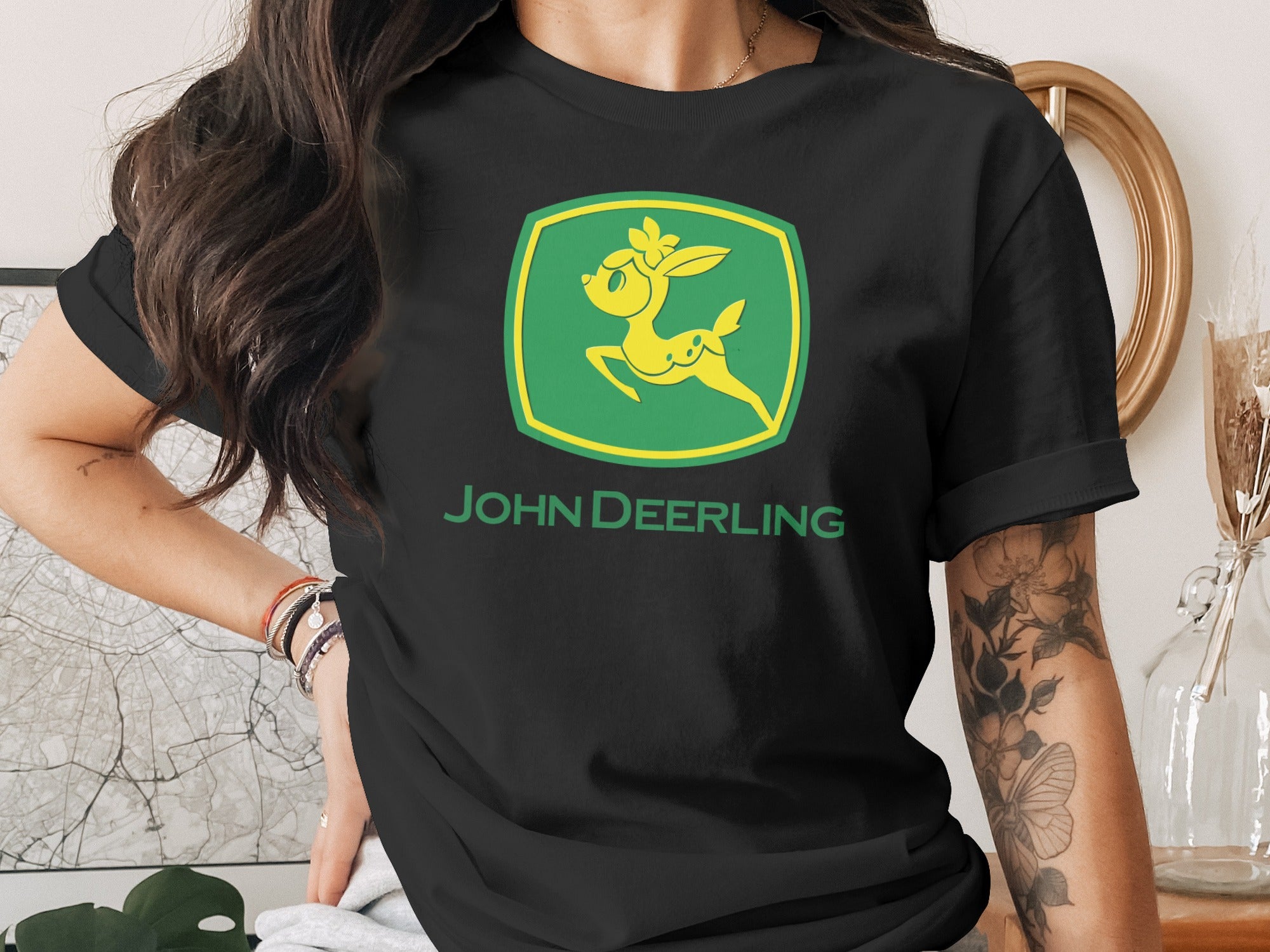 Black t-shirt featuring a yellow John Deer logo with a deer and text.