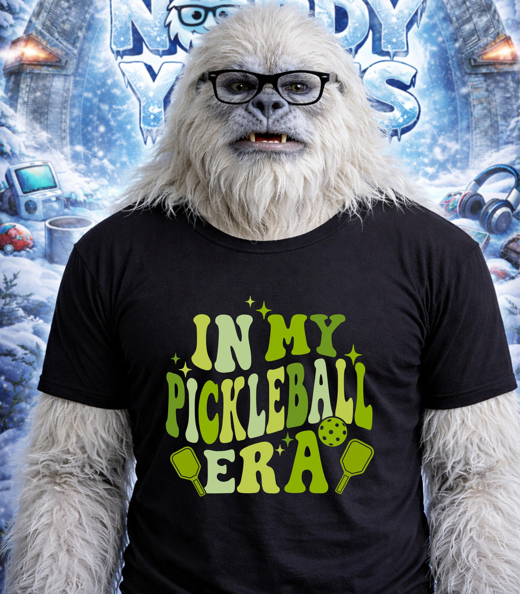 Yeti wearing glasses and a t-shirt that says "In My Pickleball Era".