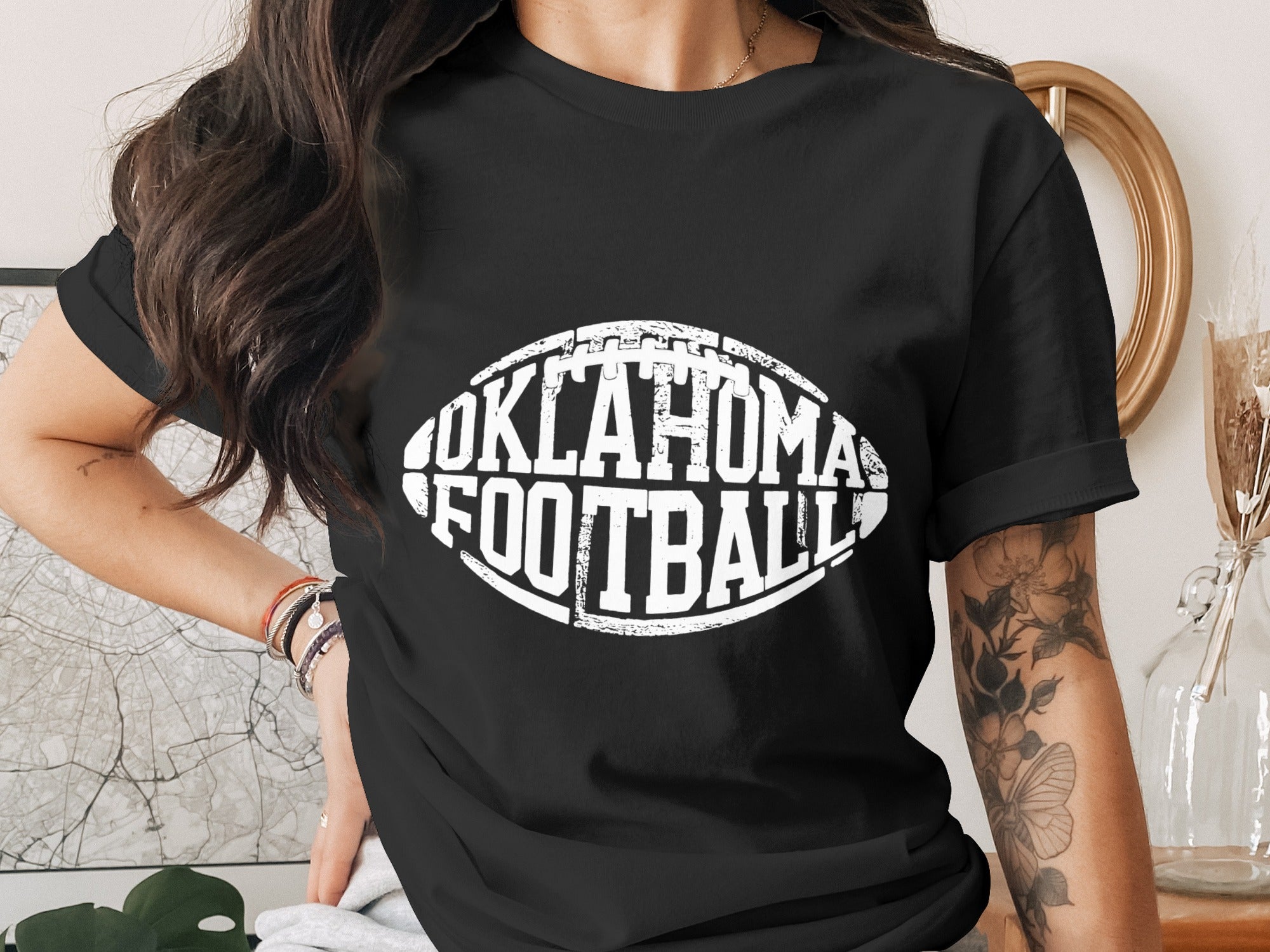Black t-shirt with white "Oklahoma Football" text in a football shape.