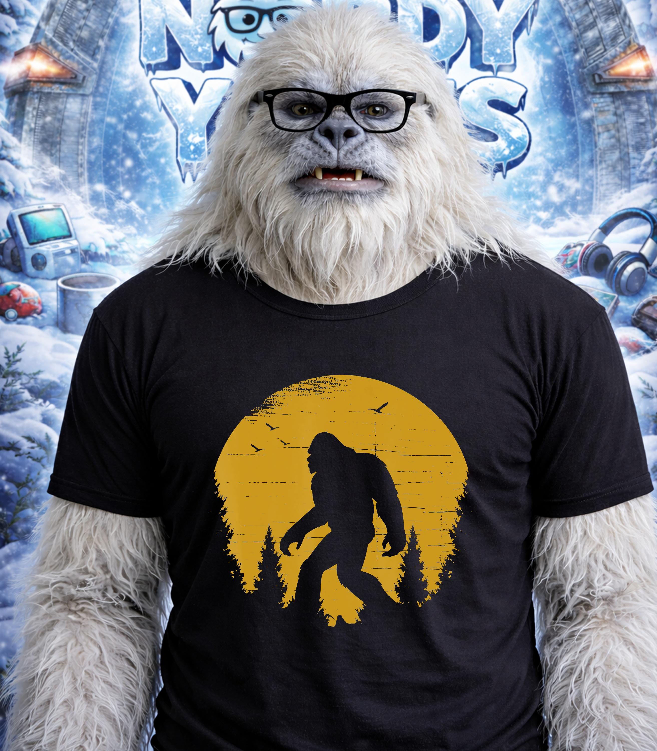Yeti wearing glasses and a black t-shirt with a yellow Bigfoot silhouette graphic.
