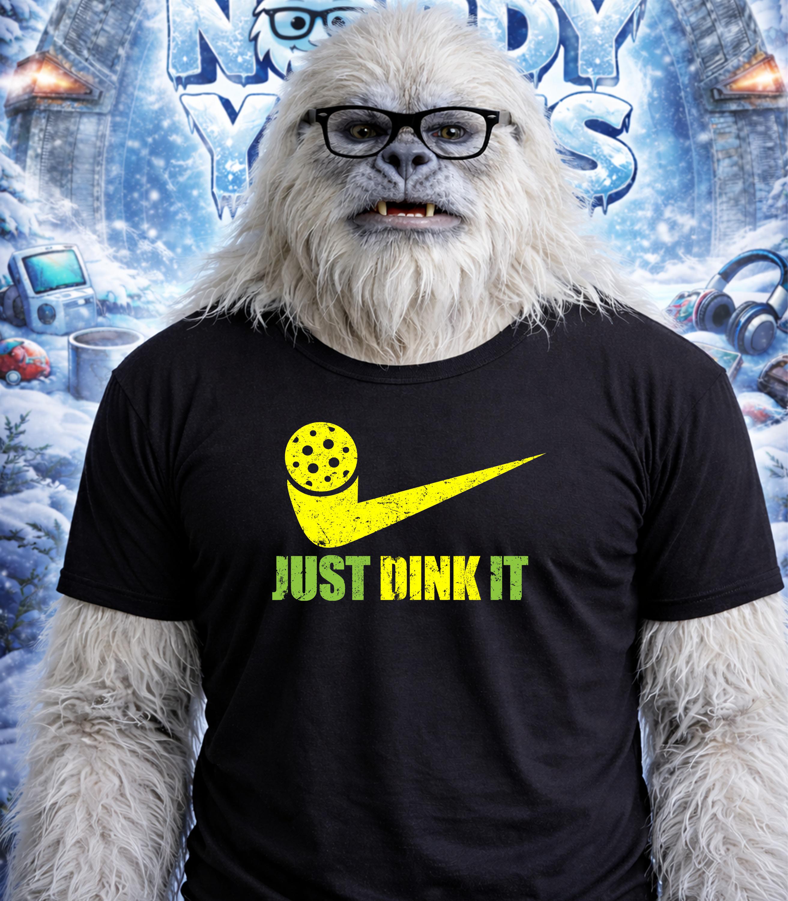 Yeti wearing black t-shirt with yellow pickleball paddle and "JUST DINK IT" text.