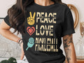 Black t-shirt with "Peace Love Pickleball" text and peace sign, heart, and pickleball graphic.