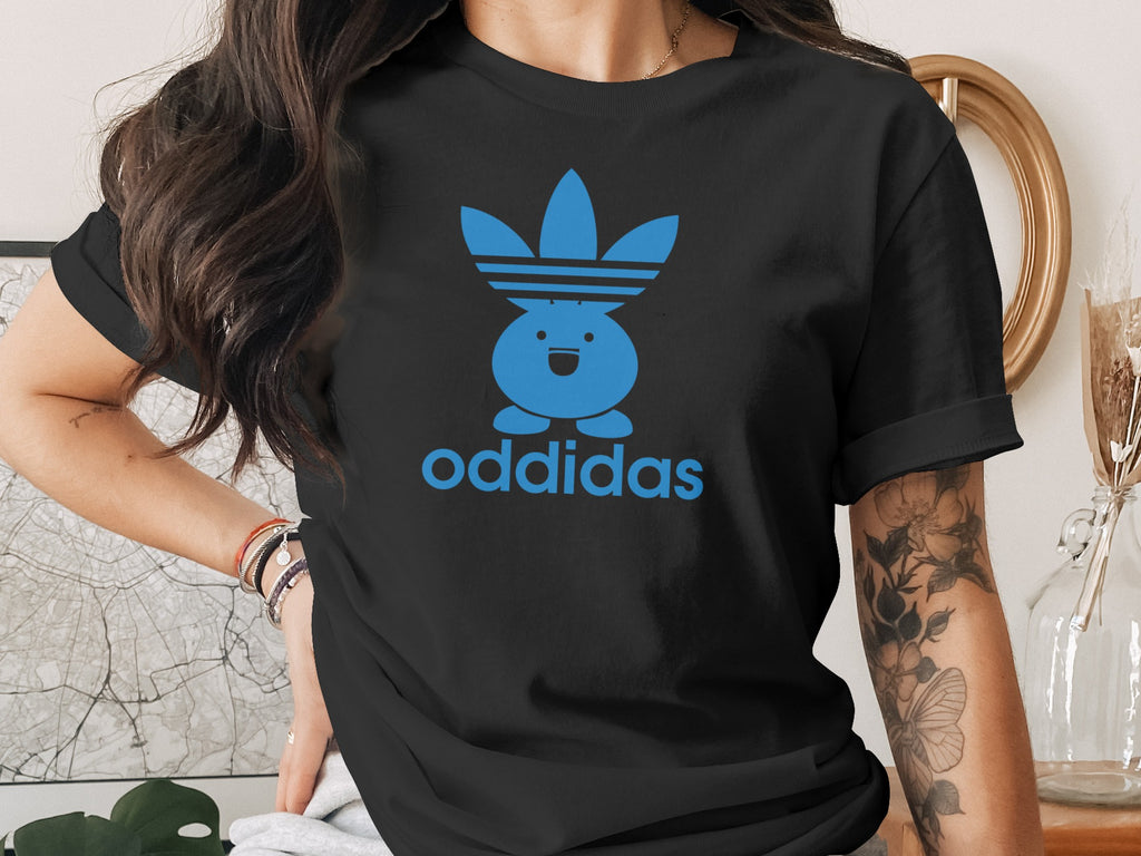 Black t-shirt with blue "oddidas" logo featuring a stylized character.