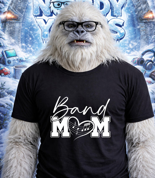 Yeti wearing a black t-shirt with "Band Mom" and a musical heart.