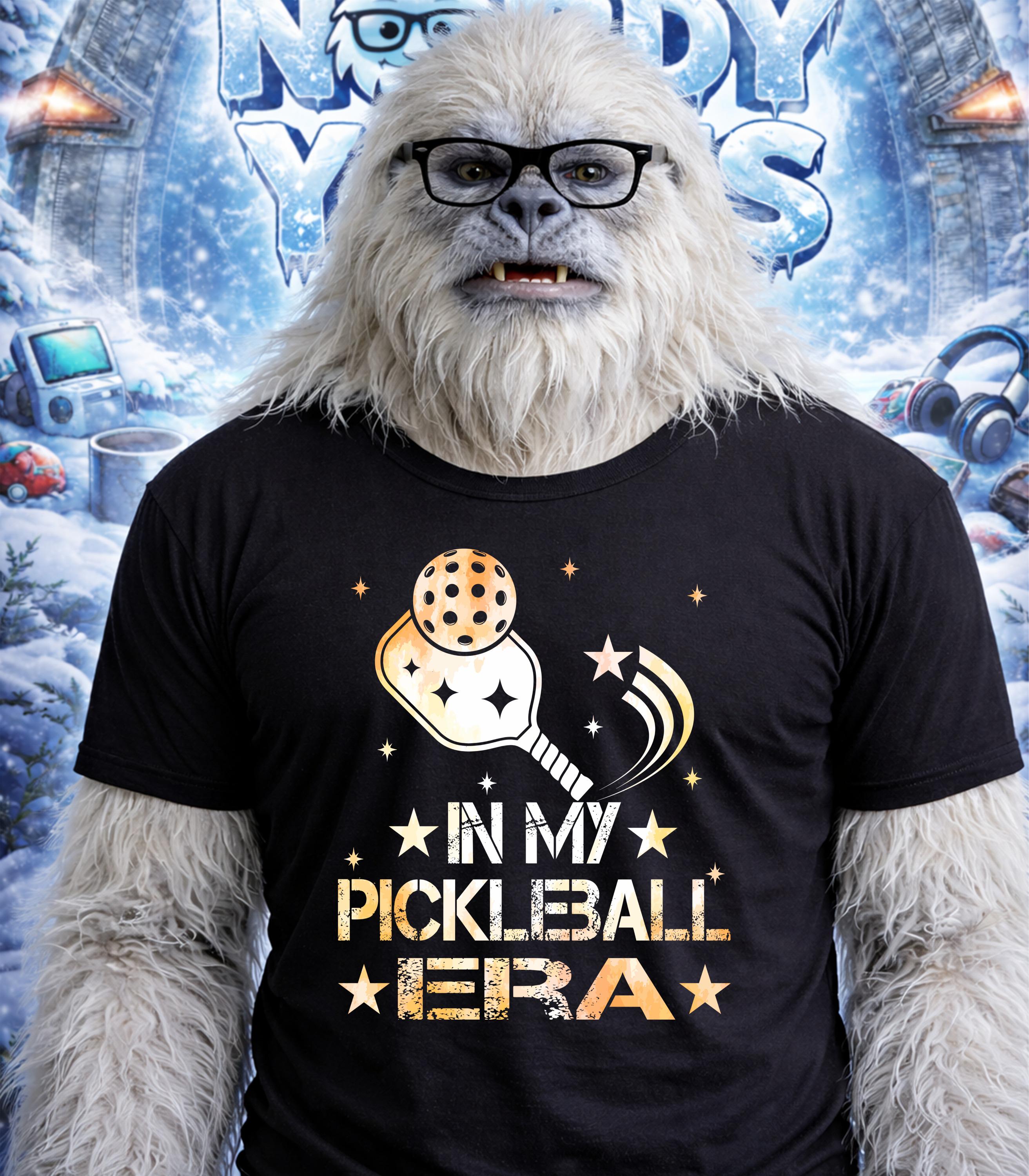 Yeti wearing glasses and t-shirt with "In My Pickleball Era" text and graphic.