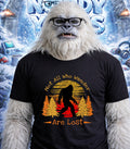 Yeti wearing glasses and a t-shirt with "Not All Who Wander Are Lost" text.