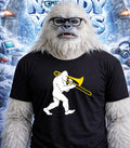 Yeti wearing glasses and a t-shirt with a trombonist graphic.