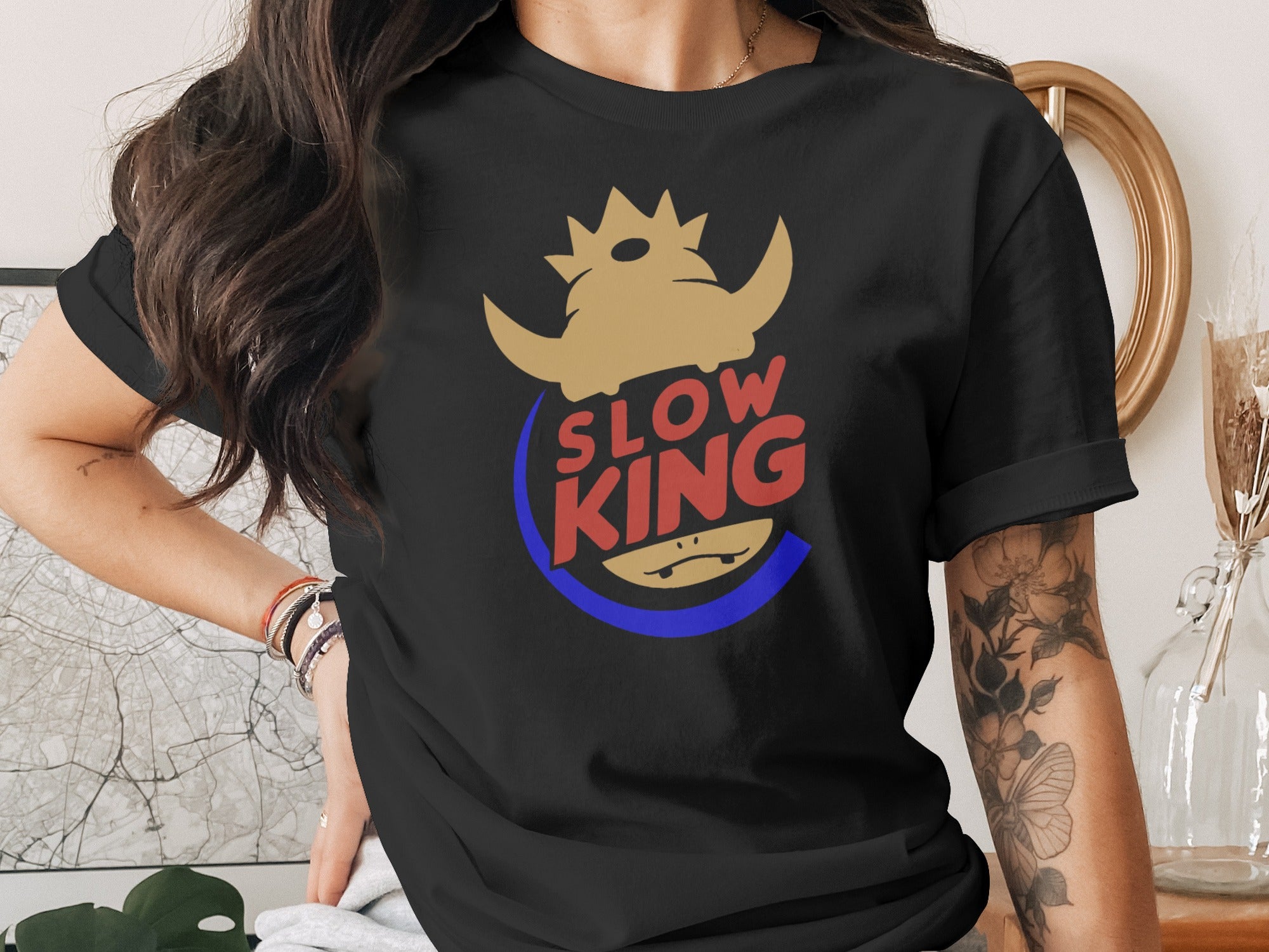 Black t-shirt with "Slow King" text and a crown-wearing creature logo.