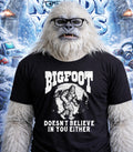 Yeti wearing glasses and a t-shirt that says "Bigfoot Doesn't Believe In You Either."