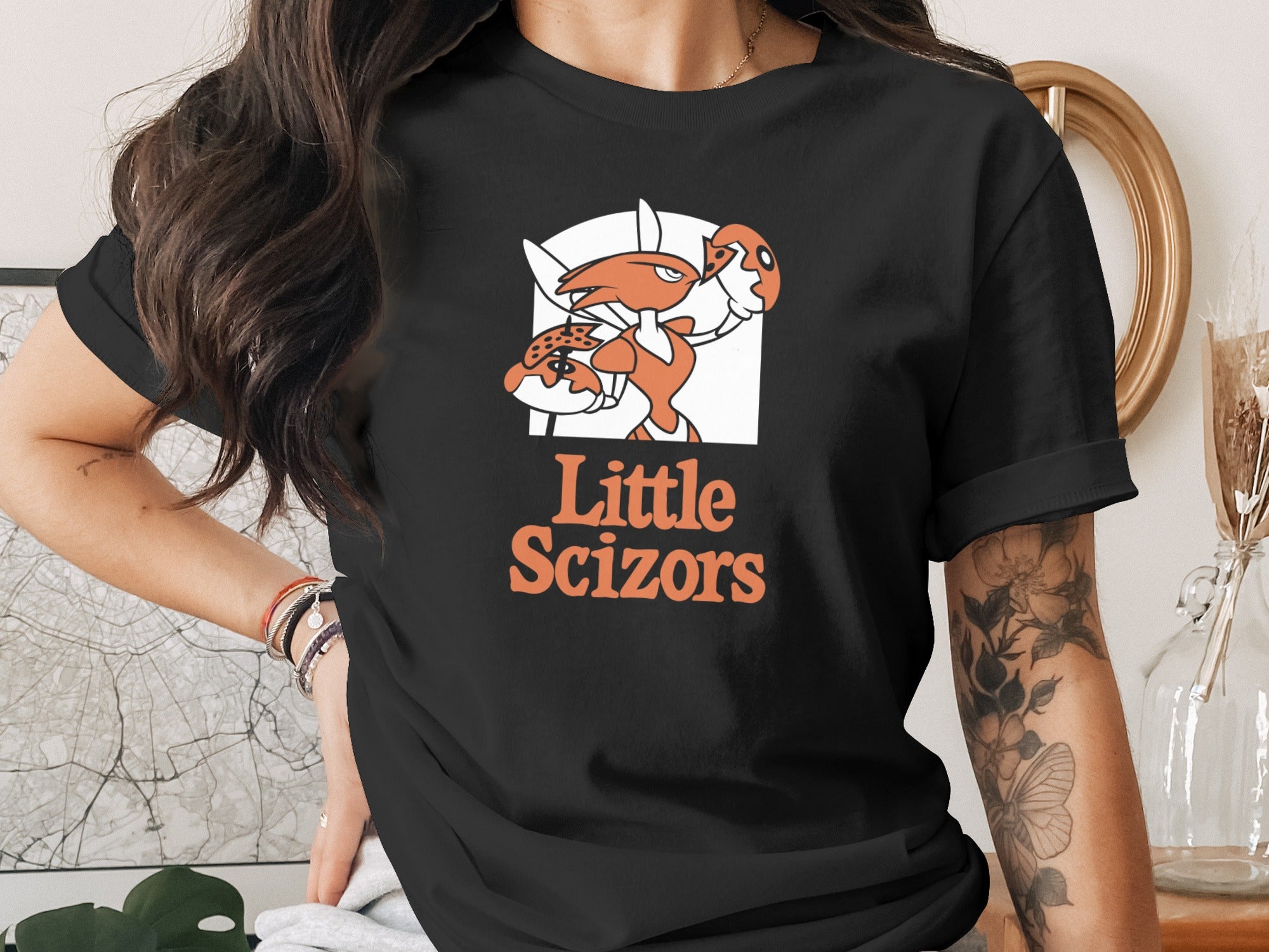 Black t-shirt with orange crab and "Little Scizzors" logo.