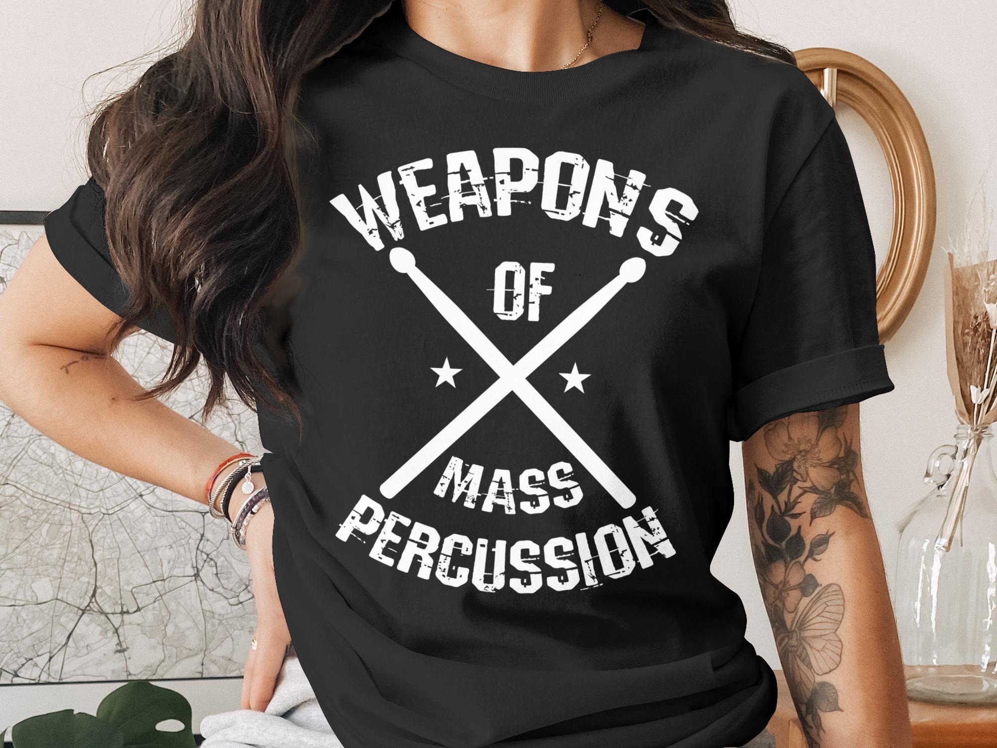 Black t-shirt with "Weapons of Mass Percussion" text and crossed drumsticks.