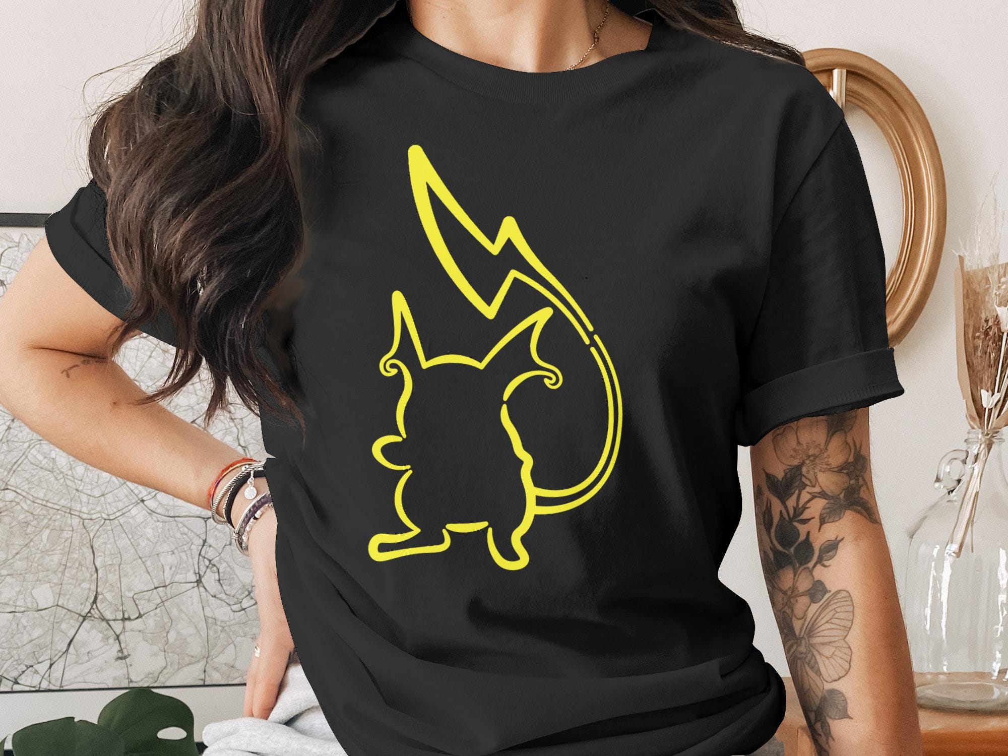 Black t-shirt with yellow Pikachu silhouette and lightning bolt design.