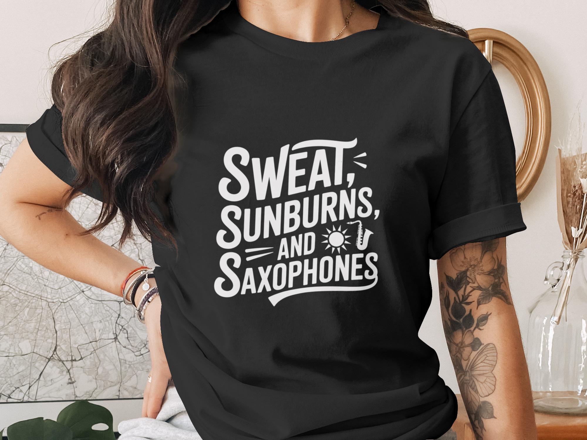 Black t-shirt with white text "Sweat, Sunburns, and Saxophones" and a sun graphic.