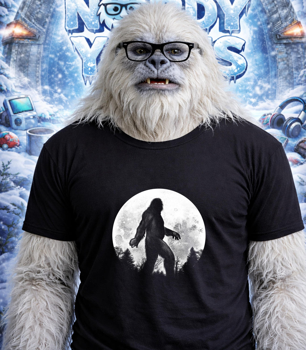 Yeti wearing glasses and a t-shirt with a Bigfoot silhouette against a full moon.