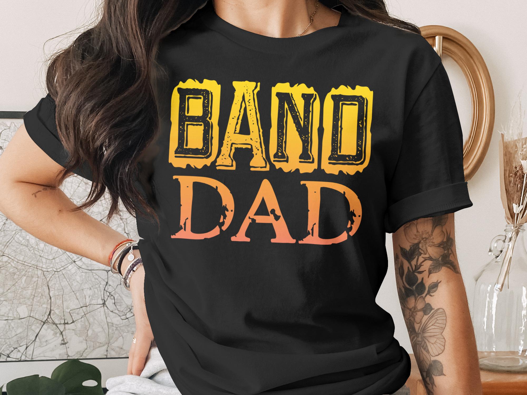 Black t-shirt with "BAND DAD" in faded yellow and orange ombre text.