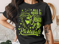 T-shirt with Jesus and pickleball graphic and text "ALL I NEED IS JESUS AND PICKLEBALL".