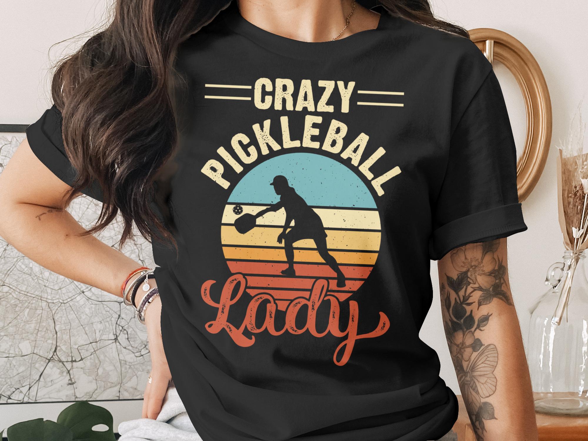 T-shirt with "Crazy Pickleball Lady" text and sunset pickleball player graphic.